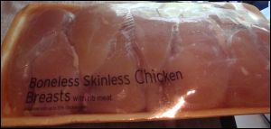 Package of boneless skinless chicken breasts, ready for making crock pot chicken.