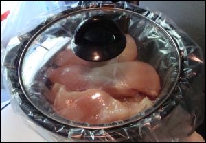 The lid is on the crock pot with the prepared chicken meat.