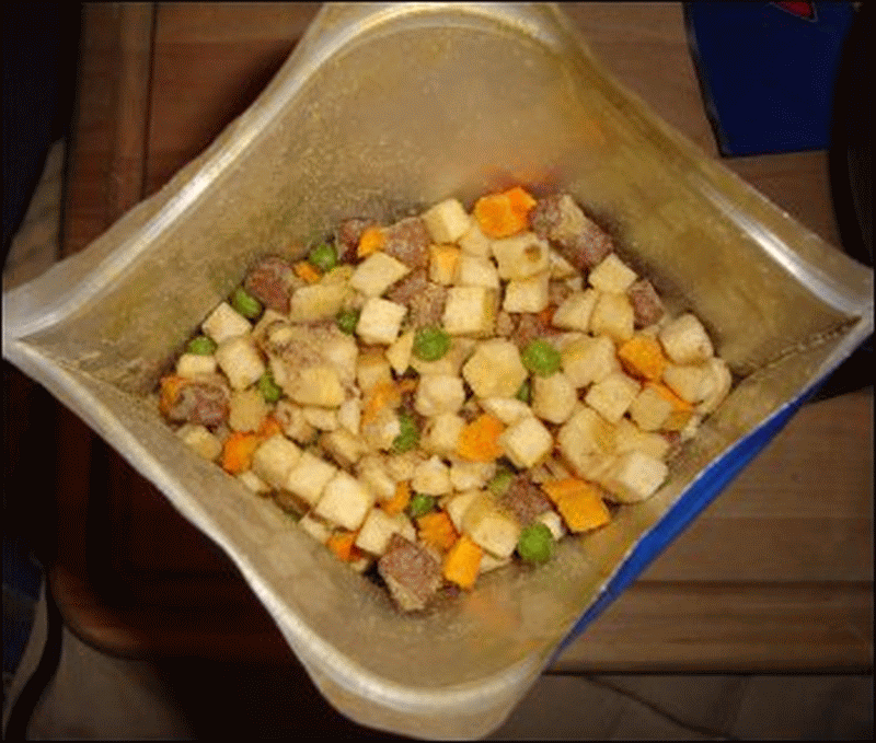 What the freeze dried beef stew looked like in the bottom of the pouch. The beige blocks are potatoes, the orange blocks are carrots, the green spheres are peas and the brown blocks are beef.
