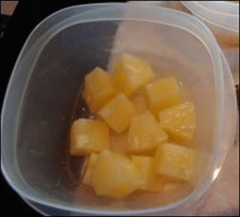 Pineapple chunks are the first layer in the fruit salad Mike fixed.