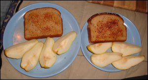 The browned grilled cheese sandwiches are served with fruit for a delicious meal.