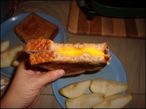 After taking a couple of bites, Vicki shows how well the cheese melted on her grilled cheese sandwich.