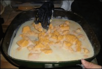 Making the cheese sauce for macaroni and cheese in an electric skillet.