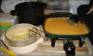 Soaking the cooked pasta in its boiling water while the cheese sauce finishes.