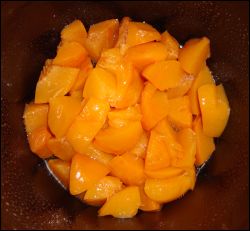 One drained quart's worth of peaches in the bottom of a crock pot sprayed with non-stick spray.