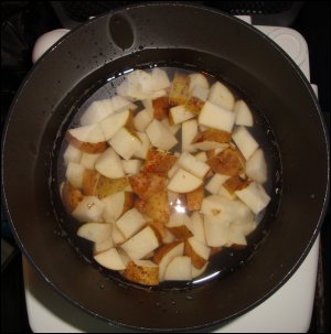 Cooking diced potatoes in the bottom of a hot pot.
