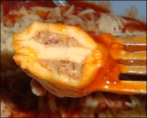 The close-up view of the meat inside the dough squares of canned ravioli we had for one meal.