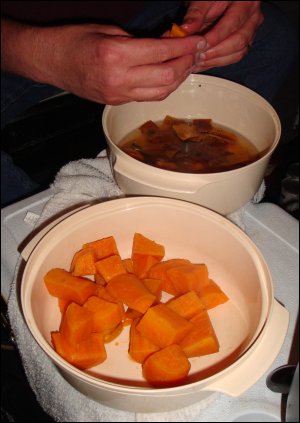 Mike peels the sweet potatoes after having drained them to a bowl and adding water. For faster cooling, some people add ice or very cold water. There is no need to 'skin' sweet potatoes prior to boiling since the skins slip off easily after boiling.