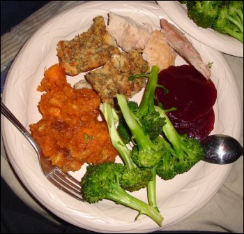 Thanksgiving dinner plate of turkey, bread dressing, sweet potato casserole and steamed broccoli, which we prepared and ate in the truck Mike drives for his trucking company.