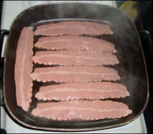 Oscar Mayer turkey bacon in an electric skillet, just after it has been removed from the package.