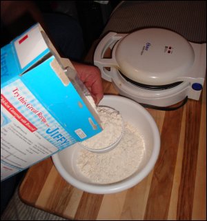 Mike measures commercially prepared baking mix into a bowl.