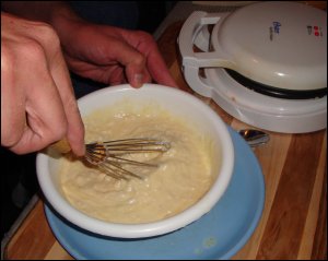 Mike mixes the waffle batter.