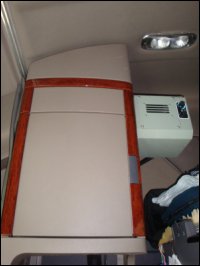 The top part of the storage cabinet behind the passenger seat.