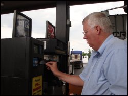 Mike Simons inserts his fuel card into a truck stop diesel pump in preparation to fuel his truck.