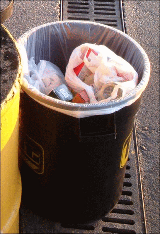 Close-up of the trash barrel at the fuel island at Pilot Travel Center in Florence, SC. Notice that it is almost completely full.