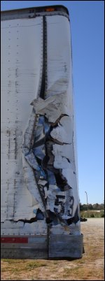 Damage to the passenger side nose of a trailer.