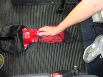 Mike Simons cleaning his truck with a Dirt Devil hand held vacuum cleaner.