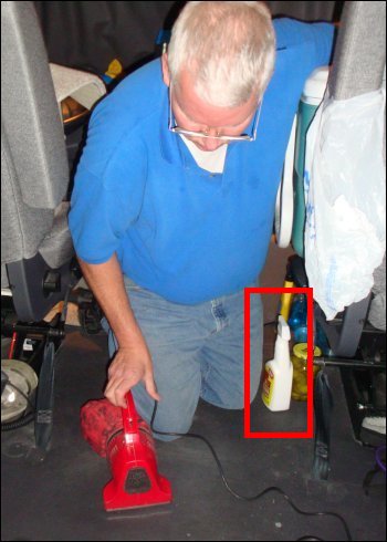Mike vacuums the floor with a trigger bottle of Krud Kutter by his side.