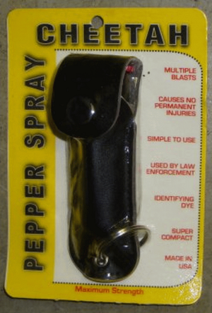 Home security pepper spray, black holster, in package.