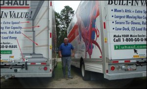 Mike Simons walks between U-Haul trucks at the moving truck rental facility where we did business.