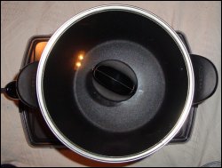 Overhead view of assembled Presto Kitchen Kettle sitting on a heat resistant surface, with electric cord attached.