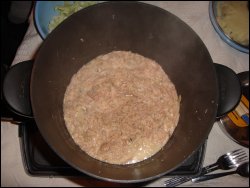 Overhead view of pork cooking in the Presto Kitchen Kettle hot pot.