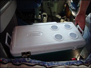 Pulling our ice chest out from under the cabinet in a large truck, getting ready to use it as a small kitchen counter top.