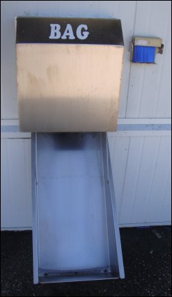 The bagged ice delivery chute on the front of an Ice House America.