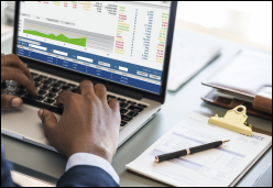 Insurance agent with paperwork and laptop computer.