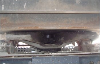 When the tractor is backed under the trailer, the fifth wheel slides around the king pin. The locking jaws are supposed to clamp around the back of the king pin to hold it firmly in place.