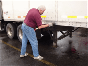 Mike Simons adjusts the height of the landing gear on his truck's trailer.