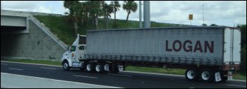 Large truck going under an overpass where there is adequate height.