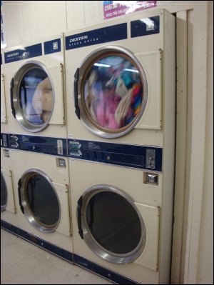 Coin-operated stack dryers in a laundromat.