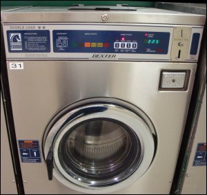 A Dexter Double Load washing machine that requires 13 quarters to operate. These machines are typically found in public laundromats.
