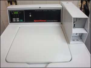 A Speed Queen coin operated washing machine.