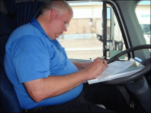 Mike Simons works on filling out his log book.