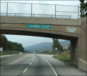An overpass marked as a low clearance that applies to the shoulder only.