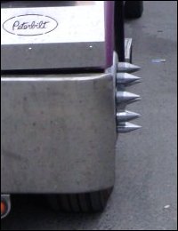 A side view of spiked lug nut covers on a big truck.