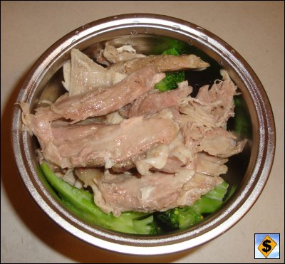The bowl, with a capacity of about 2.5 cups, is filled with food. This meal contained turkey, bread dressing and frozen broccoli.