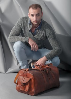 Man with a leather bag, perfect for use as a shower bag.