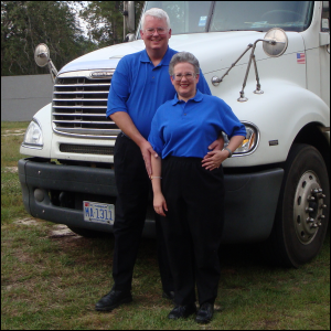 Mike and Vicki Simons, standing next to the truck that Mike drove for Epes Transport.