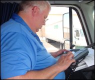 Professional truck driver Mike Simons, communicating with his company by Qualcomm Mobile Communications Terminal.