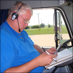 Mike Simons wearing his headset and on his cell phone.