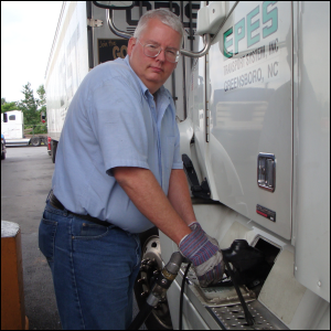 Mike Simons putting diesel fuel in a truck that he drove regionally.