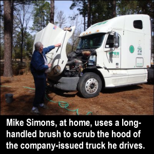 Mike Simons, at home, uses a long-handled brush to scrub the hood of the company-issued truck he drives.