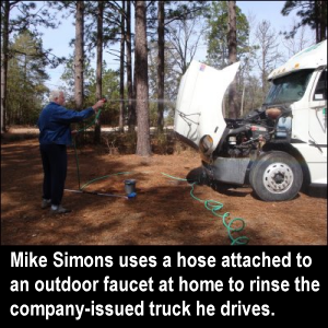 Mike Simons uses a hose attached to an outdoor faucet at home to rinse the company-issued truck he drives.