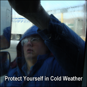 Mike Simons is wearing a winter coat while cleaning a window. Protect yourself in cold weather.