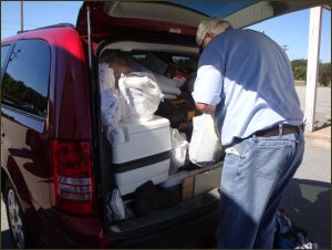 Packing up all the stuff from the truck into a minivan.