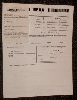 Stack of paperwork representing a load, scanned in with a confirmation slip from Transflo Express, all stapled together at the top.