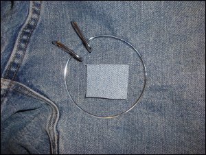 Sizing the patch to the hole in the jeans needing patching.